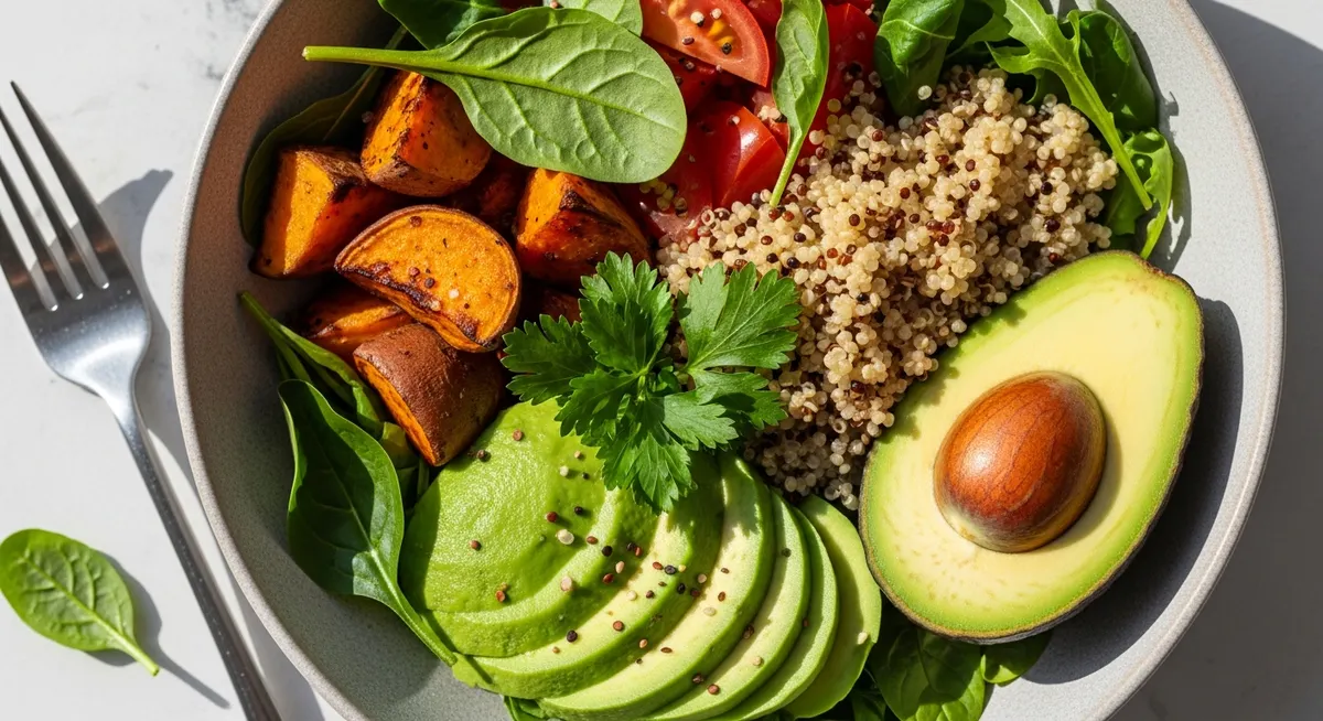 A colorful, healthy meal bowl filled with fresh vegetables, grains, and avocado.